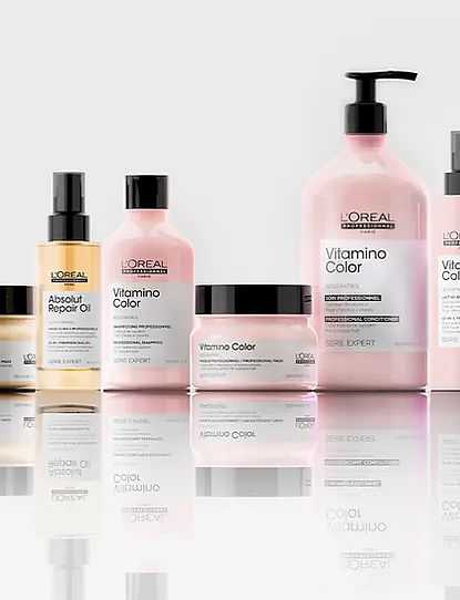 L'Oréal hair care products arranged on reflective surface.