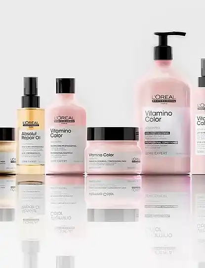 L'Oréal hair care products arranged on reflective surface.