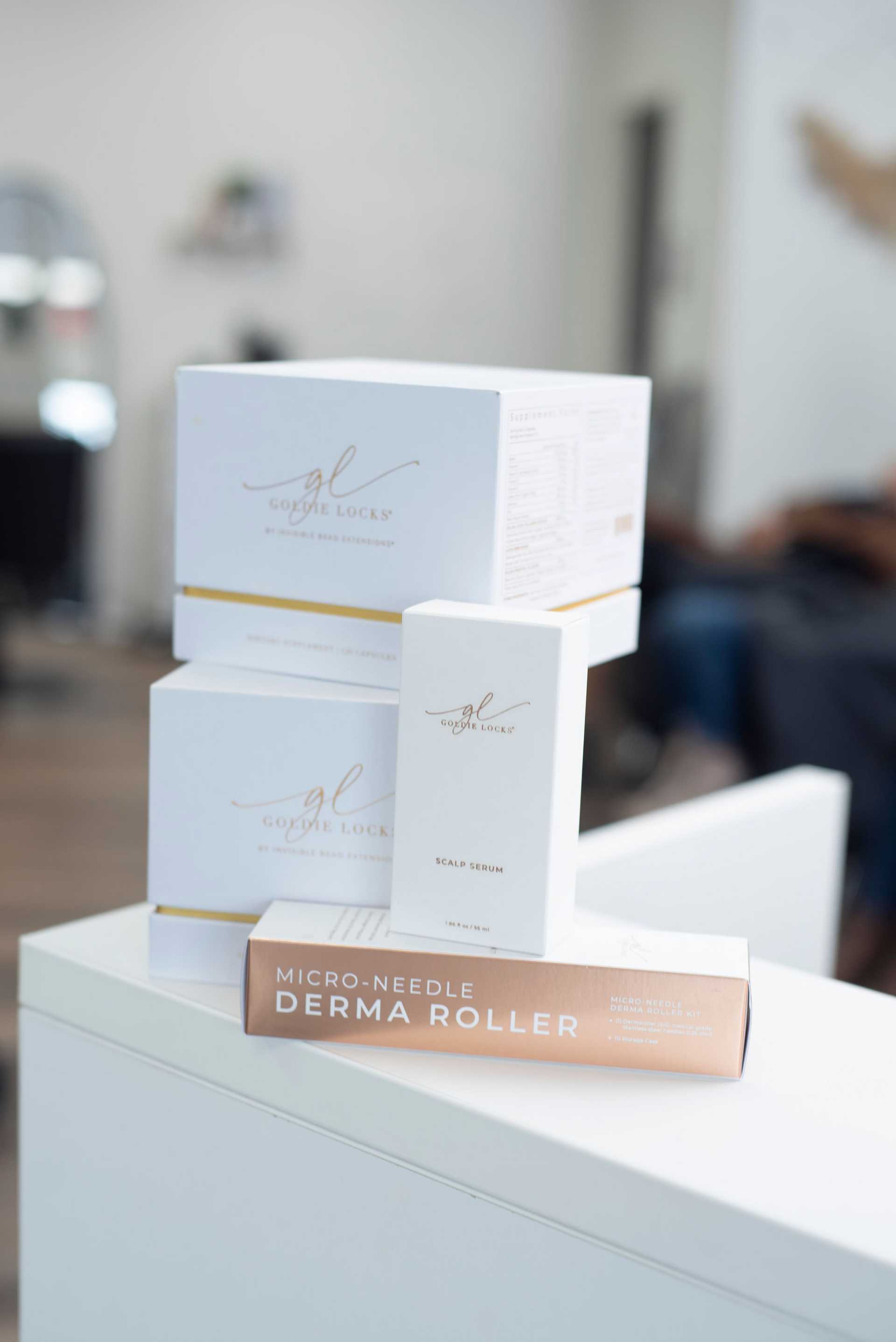 Boxes of beauty products with brand 'Goldie Locks' on a table.
